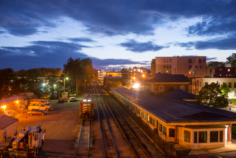 train station in Charlottesville at sunset with a train coming in on the tracks